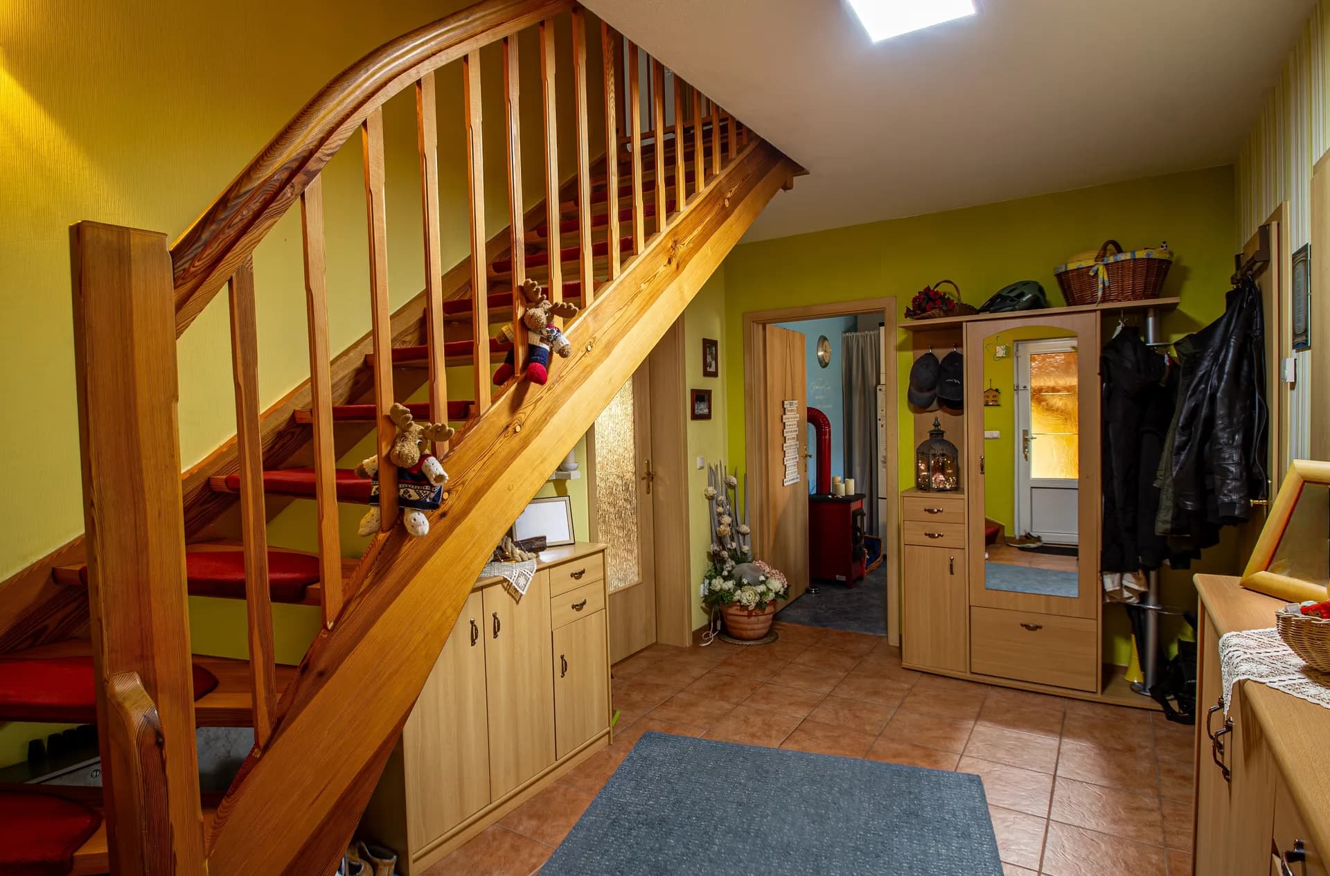 Heller Eingangsbereich mit Einbauschränken für Garderobe und Platz für Schuhe, mit Zugang zum Treppenaufgang.